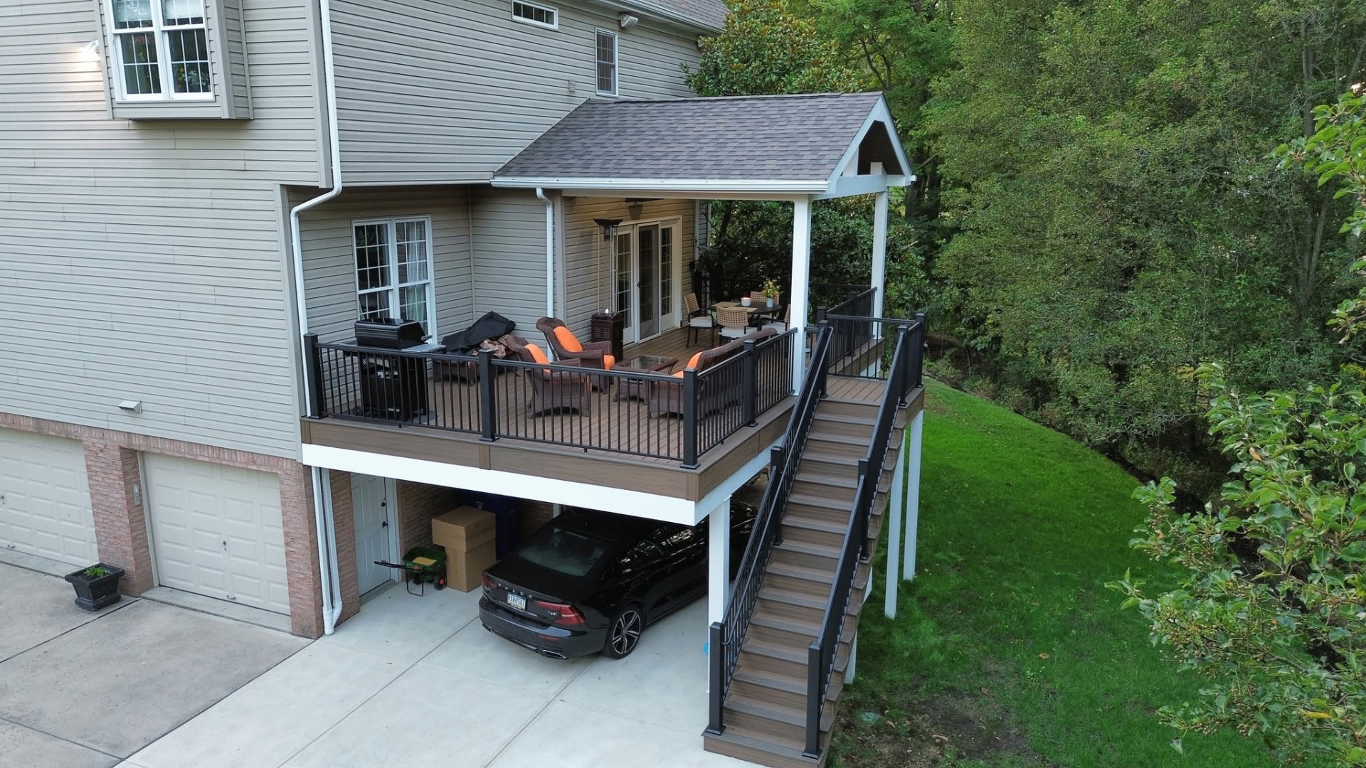 Covered deck with stairs and black railings built by Veterans Decks